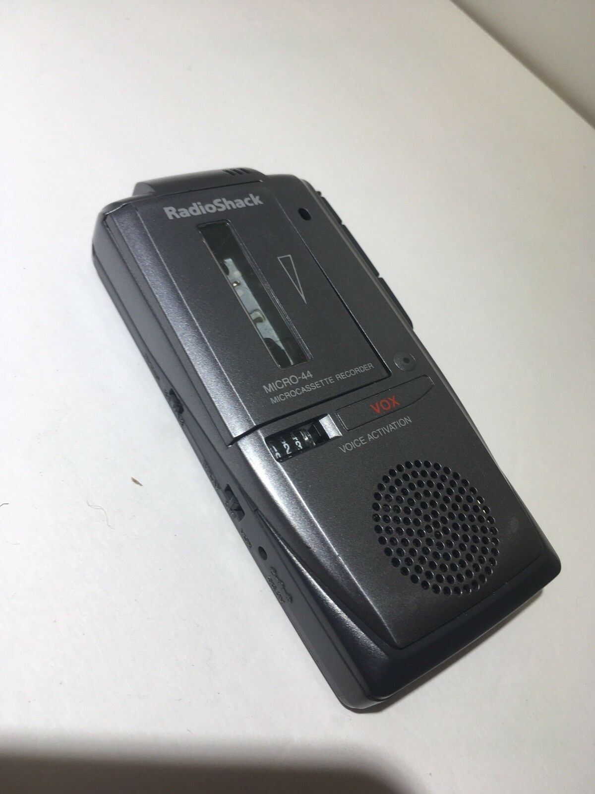 Close-up view of Radio Shack Micro-44 Micro Cassette Recorder highlighting its sleek design and function, perfect for vintage audio enthusiasts.