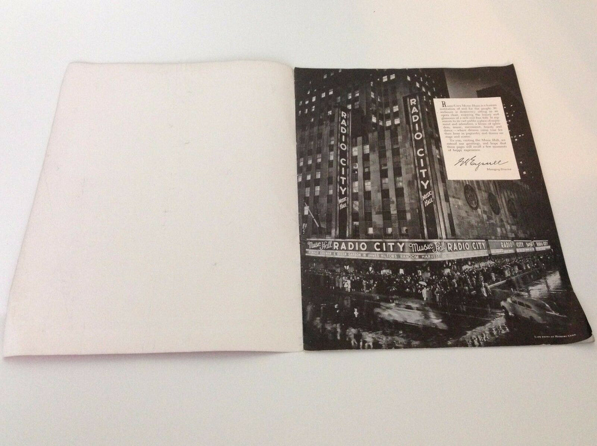 Back cover of Down Beat Magazine from November 18, 1953, displaying a nighttime view of Radio City Music Hall, enhancing the cultural significance of the magazine featuring Guy Mitchell and Liberace.