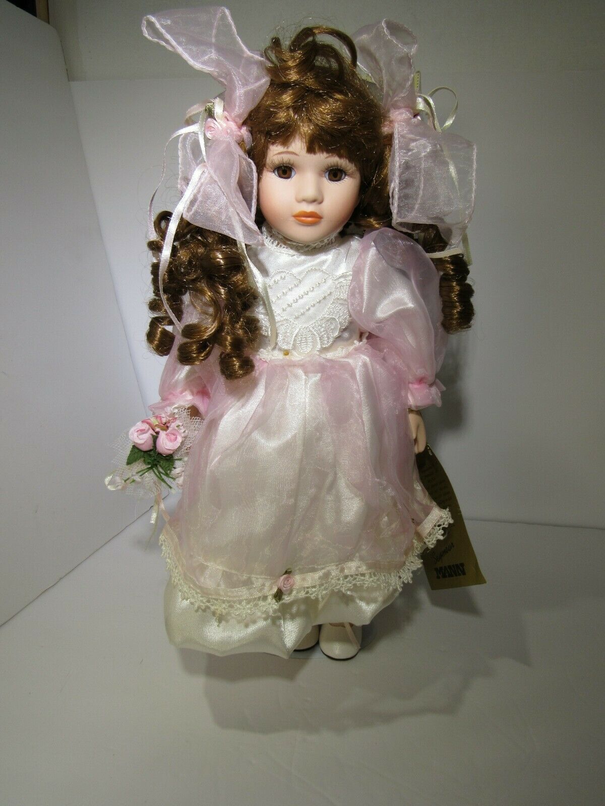 SEYMOUR MANN 'SALLY' Connoisseur Collection doll, 16-inch, mint condition, dressed in a pink gown with long brown curls, accompanied by a bouquet of flowers.