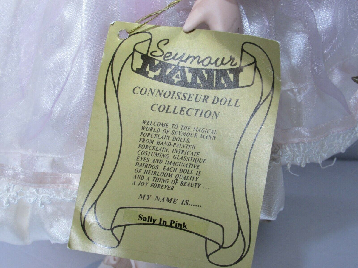 Certificate tag for SEYMOUR MANN 'SALLY' Connoisseur Collection doll, describing features of the doll and its artistry.