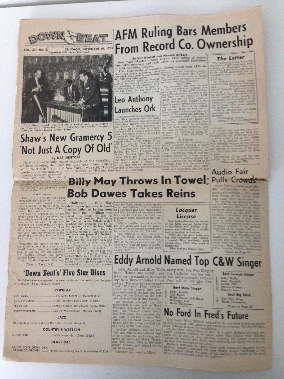 Inside page of Down Beat Magazine from November 18, 1953, discussing music industry news and featuring notable artists.