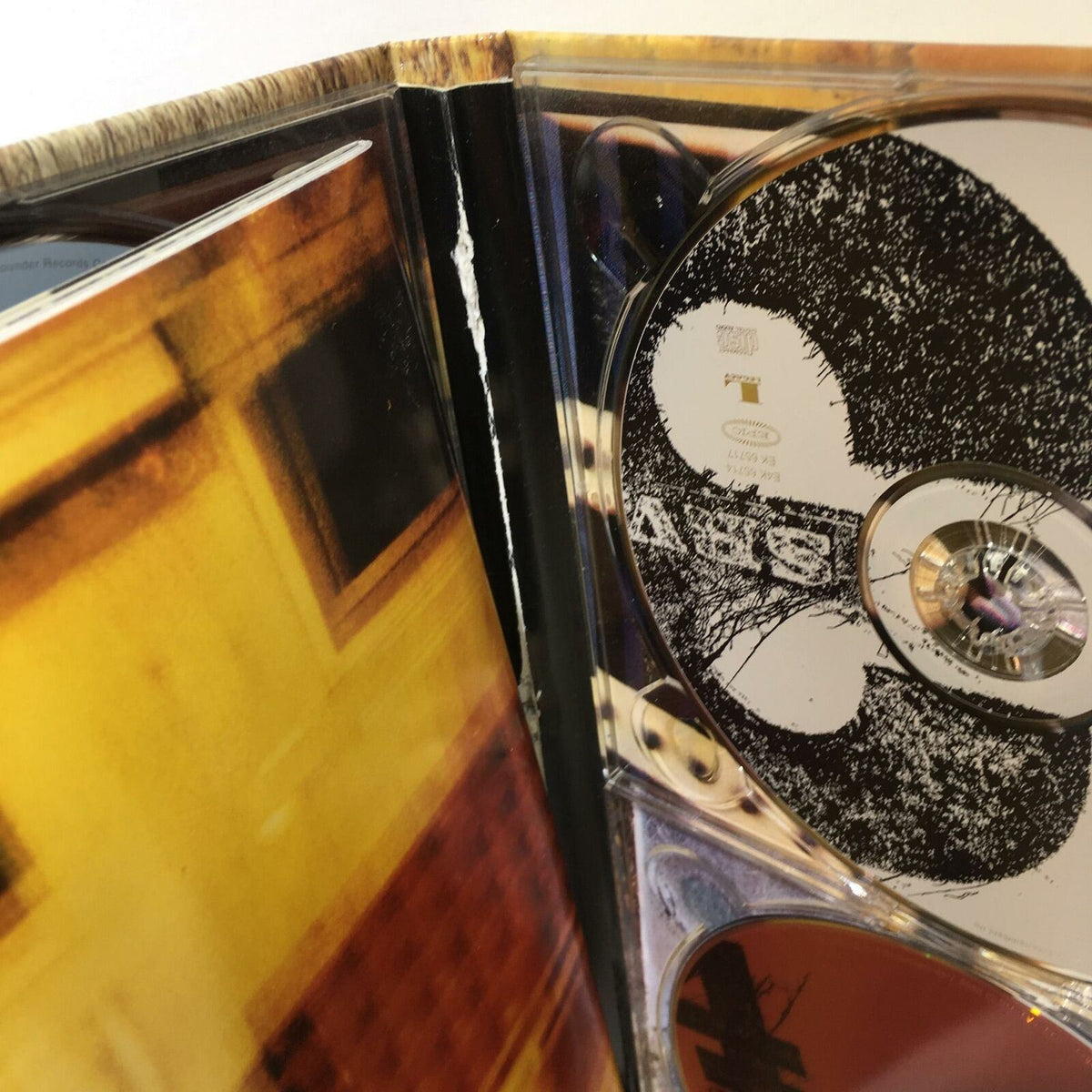 Inside view of Stevie Ray Vaughan And Double Trouble 4 Disc Box Set Audio CD highlighting the disc and edge condition.