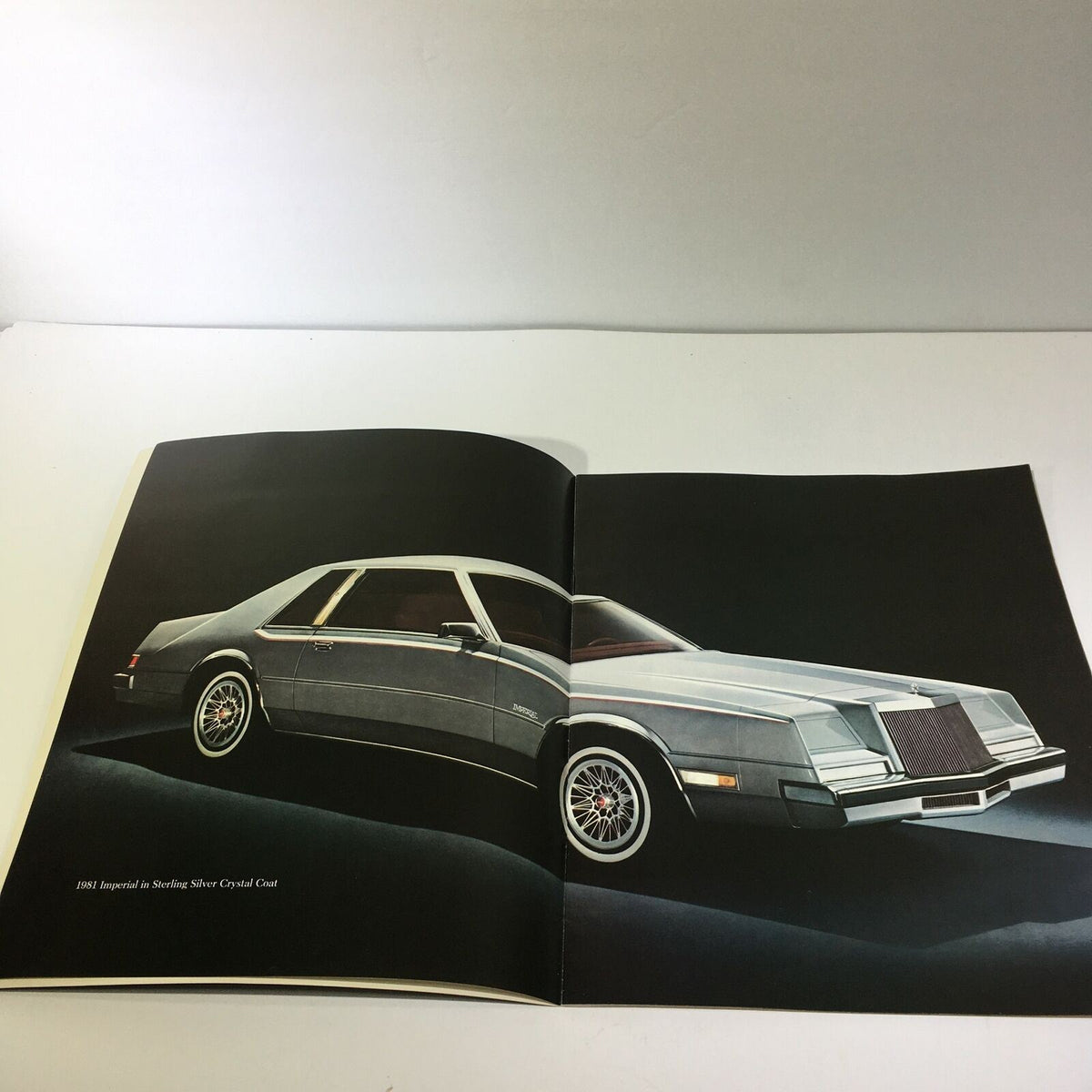Interior view of the 1981 Imperial in Sterling Silver Crystal Coat - Imperial Car Sale Brochure, showcasing the elegantly designed exterior of the silver luxury car.