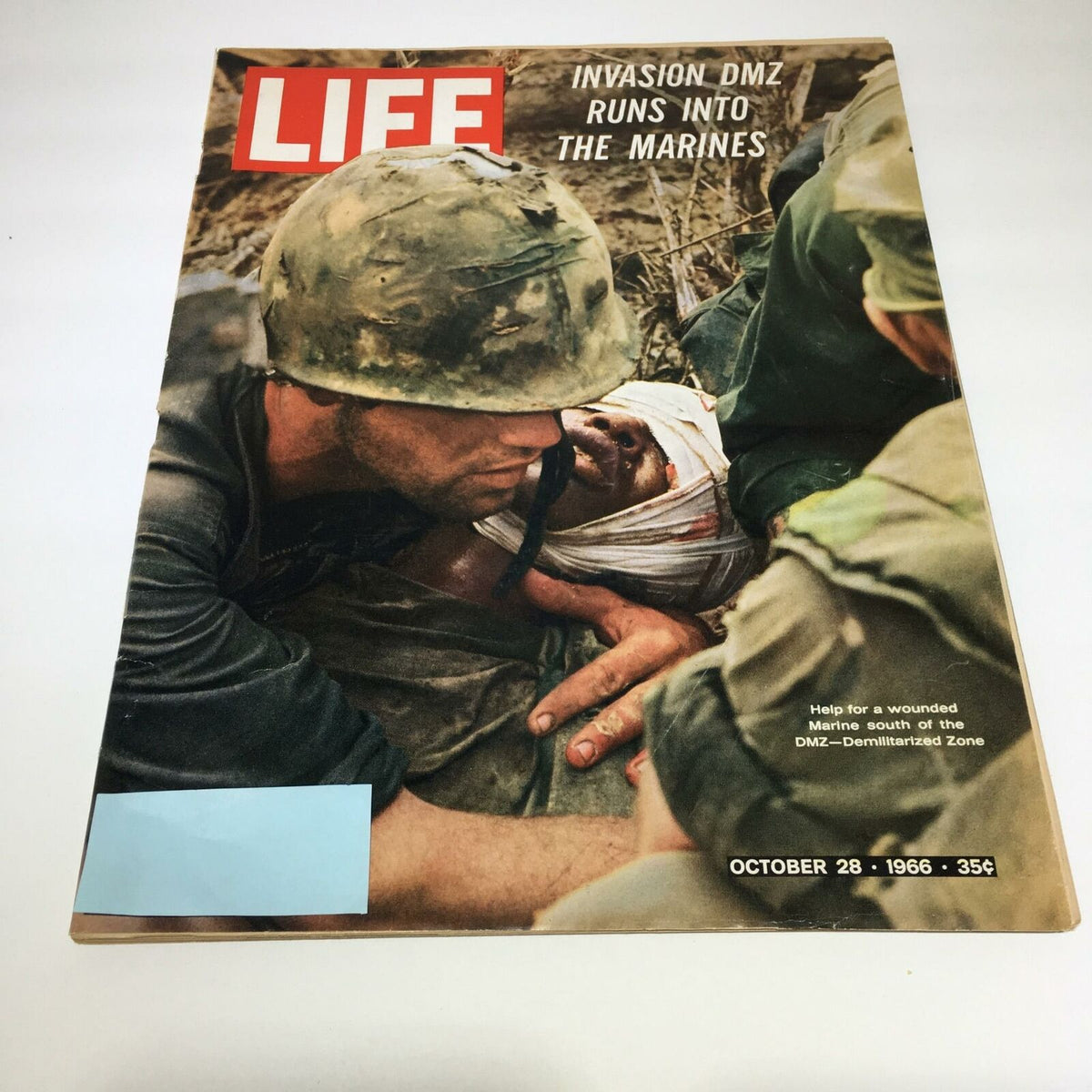 VTG Life Magazine Cover from October 28, 1966, featuring the headline 'Invasion DMZ Runs Into The Marines' with an image depicting a Marine helping a wounded comrade in the Demilitarized Zone.