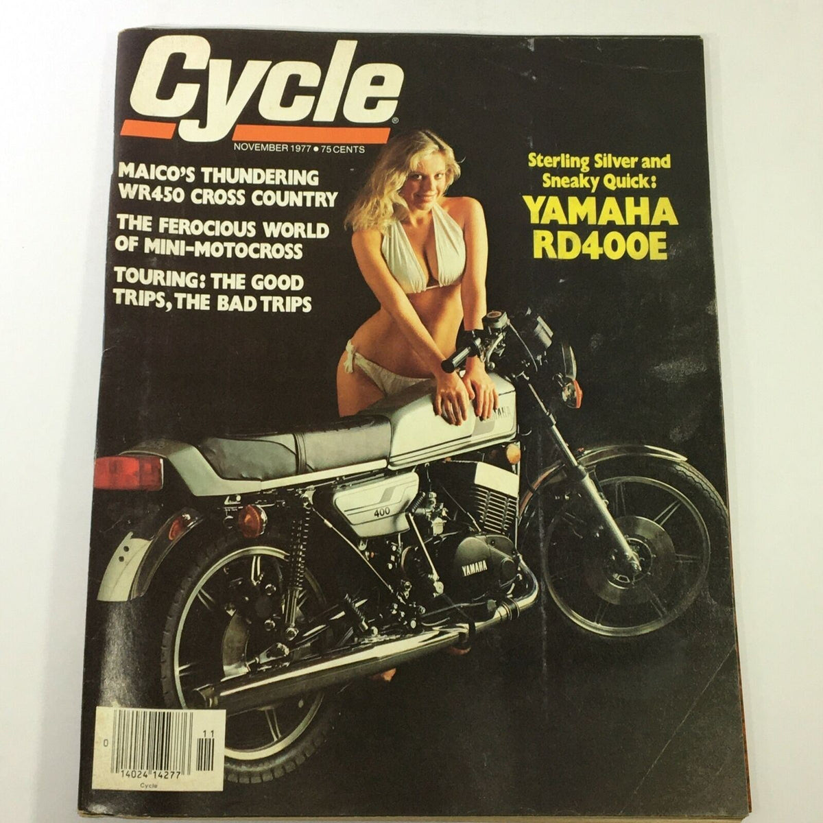 Cover of VTG Cycle Magazine November 1977 featuring the Yamaha RD400E motorcycle and the Maico WR450 Cross Country, showcasing vintage motorcycle culture with a model in a bikini beside the bike.