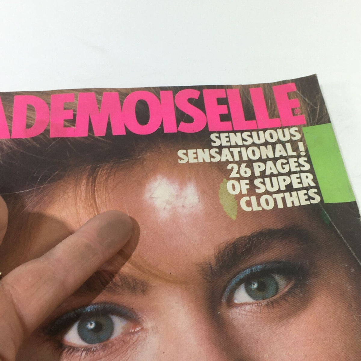 Close-up view of the prominent title and details on the cover of VTG Mademoiselle Magazine January 1983, showcasing fashion articles and beauty tips.