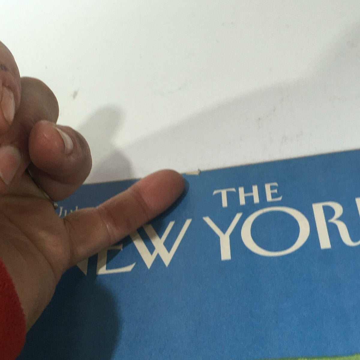 A close-up view of The New Yorker Magazine July 29 1985 with a finger pointing at the top edge, showcasing minor wear typical of a vintage publication.