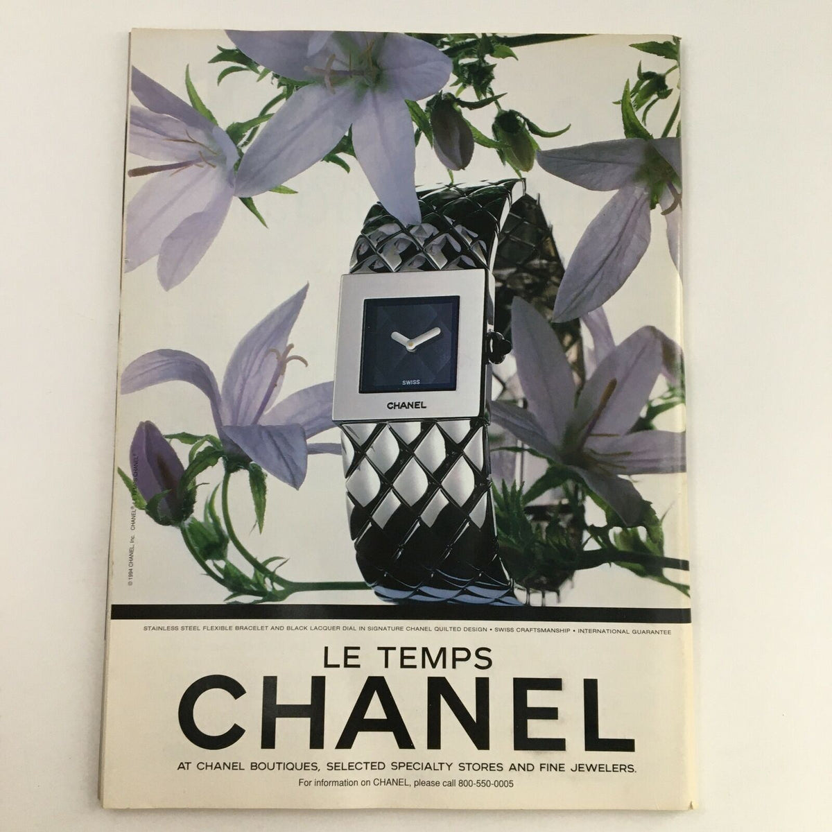 Chanel advertisement featuring a stylish watch accompanied by delicate purple flowers, highlighting the elegant design and craftsmanship of the timepiece. The ad presents the essence of luxury associated with the brand.