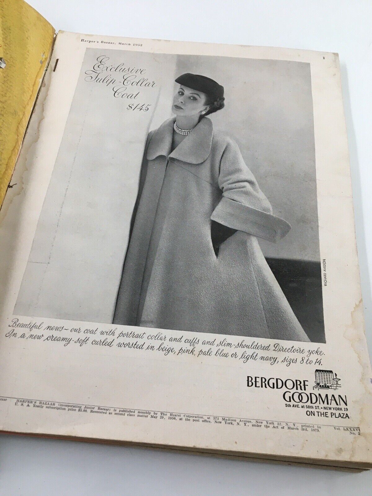Harper's Bazaar March 1952 Fashion Magazine featuring an Exclusive Tulip Collar Coat advertisement with a model showcasing the coat.