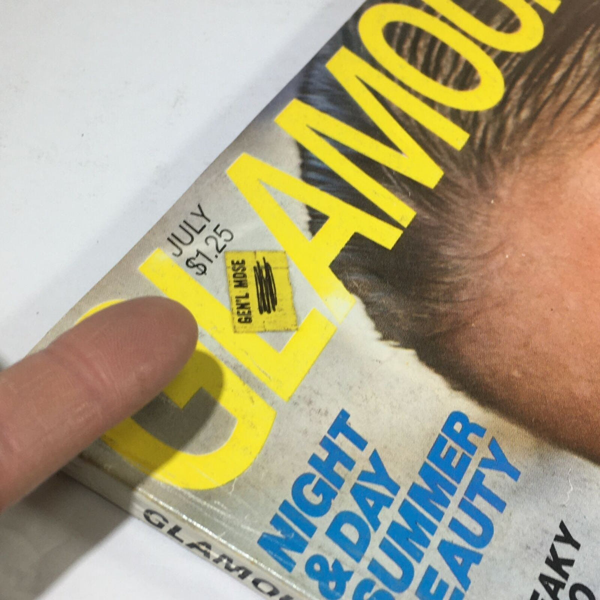 Close-up of the July 1978 VTG Glamour Magazine cover featuring a price sticker. Vintage magazine details including price of $1.25 and the title GLAMOUR prominently displayed.