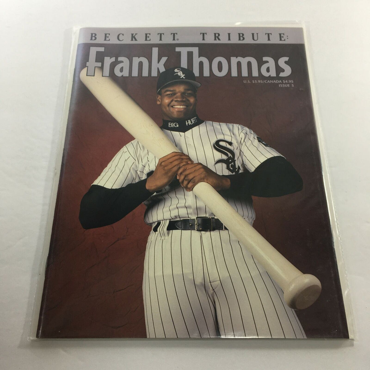 Beckett Tribute: 1994 Issue #5 featuring Chicago White Sox player Frank Thomas, showcasing him holding a baseball bat and wearing the team's iconic uniform.