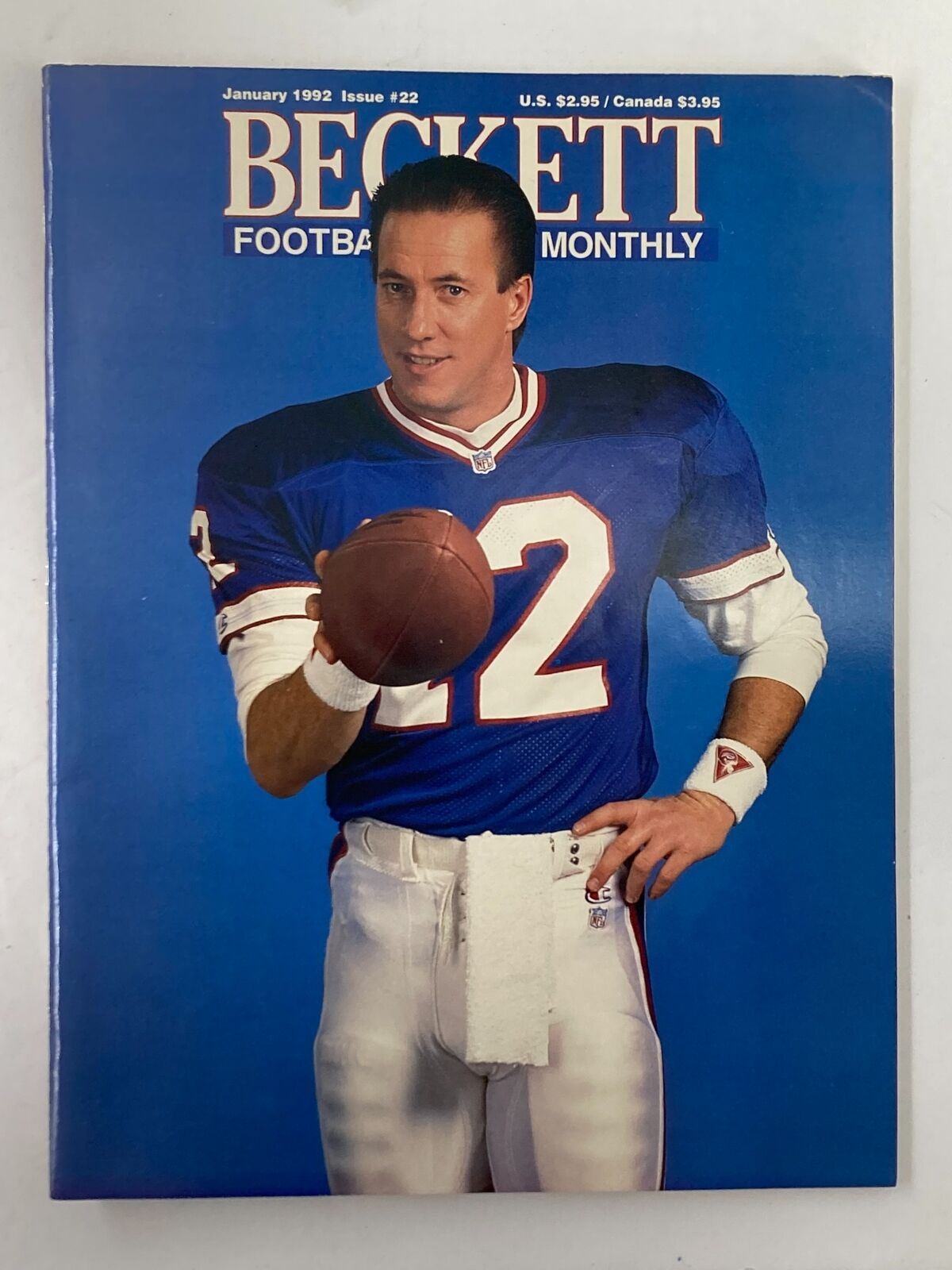 Cover of Beckett Football Card Monthly January 1992 Vol 4 #1 featuring Jim Kelly in a blue football jersey, holding a football with a blue background.