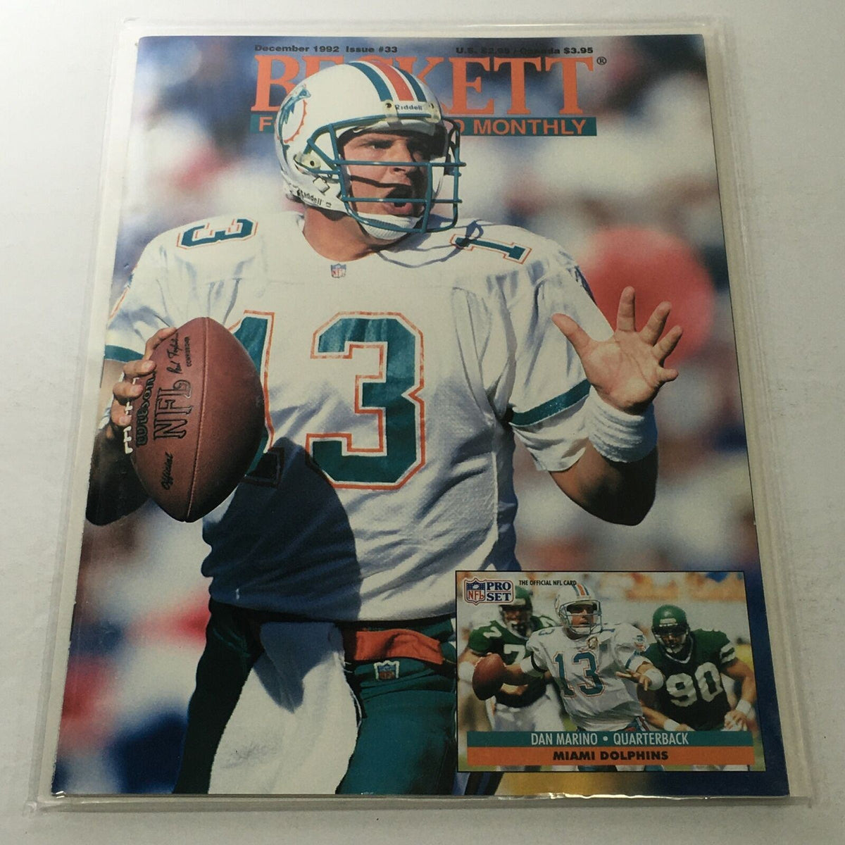 Beckett Football Card Monthly: December 1992 Issue #33 featuring NFL quarterback Dan Marino of the Miami Dolphins, showcasing him in action on the cover.