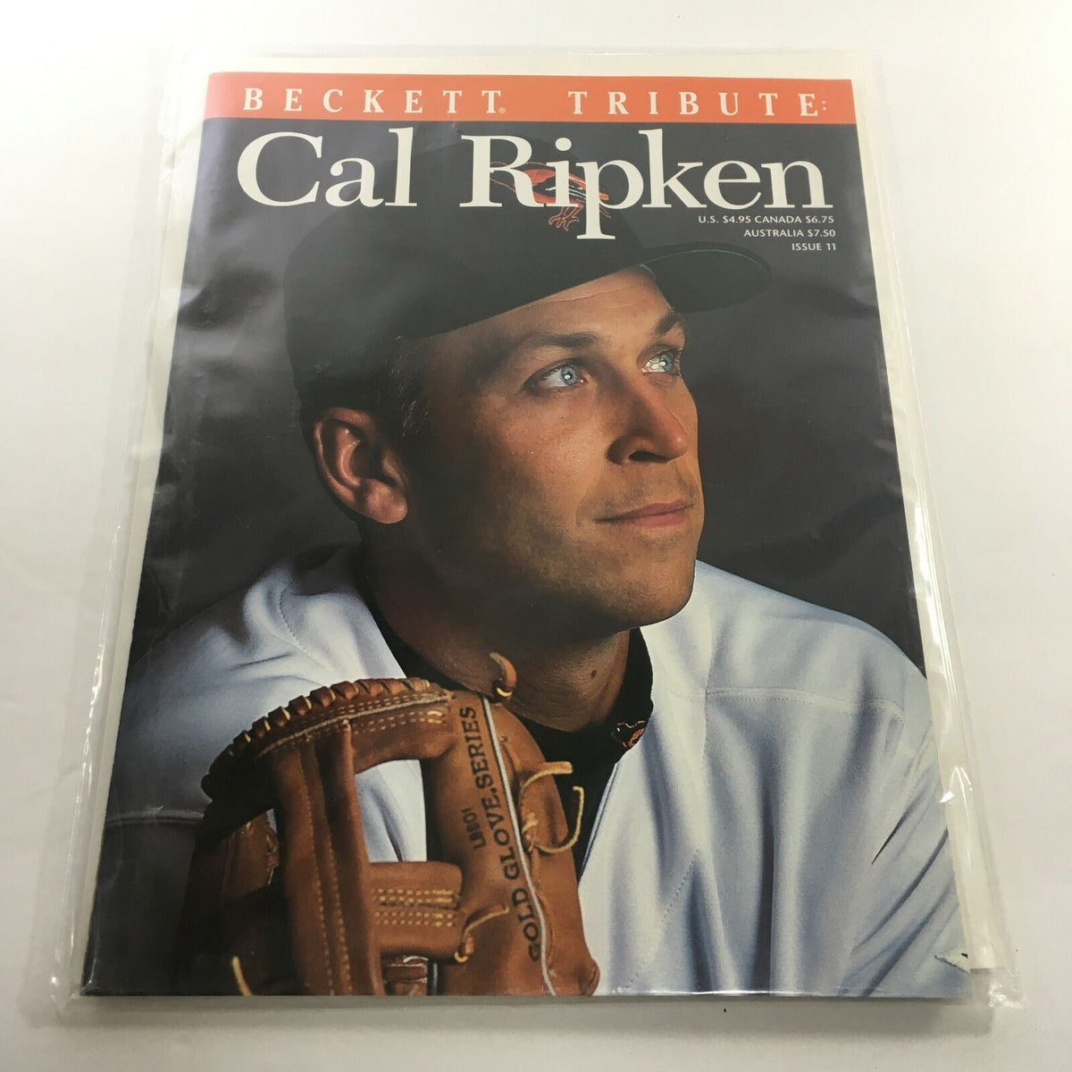 Beckett Tribute Magazine: 1995 - Cal Ripken Jr. Tribute Issue No. 11 featuring Cal Ripken Jr. looking thoughtfully, with a baseball glove in the foreground, capturing the essence of his legendary career.