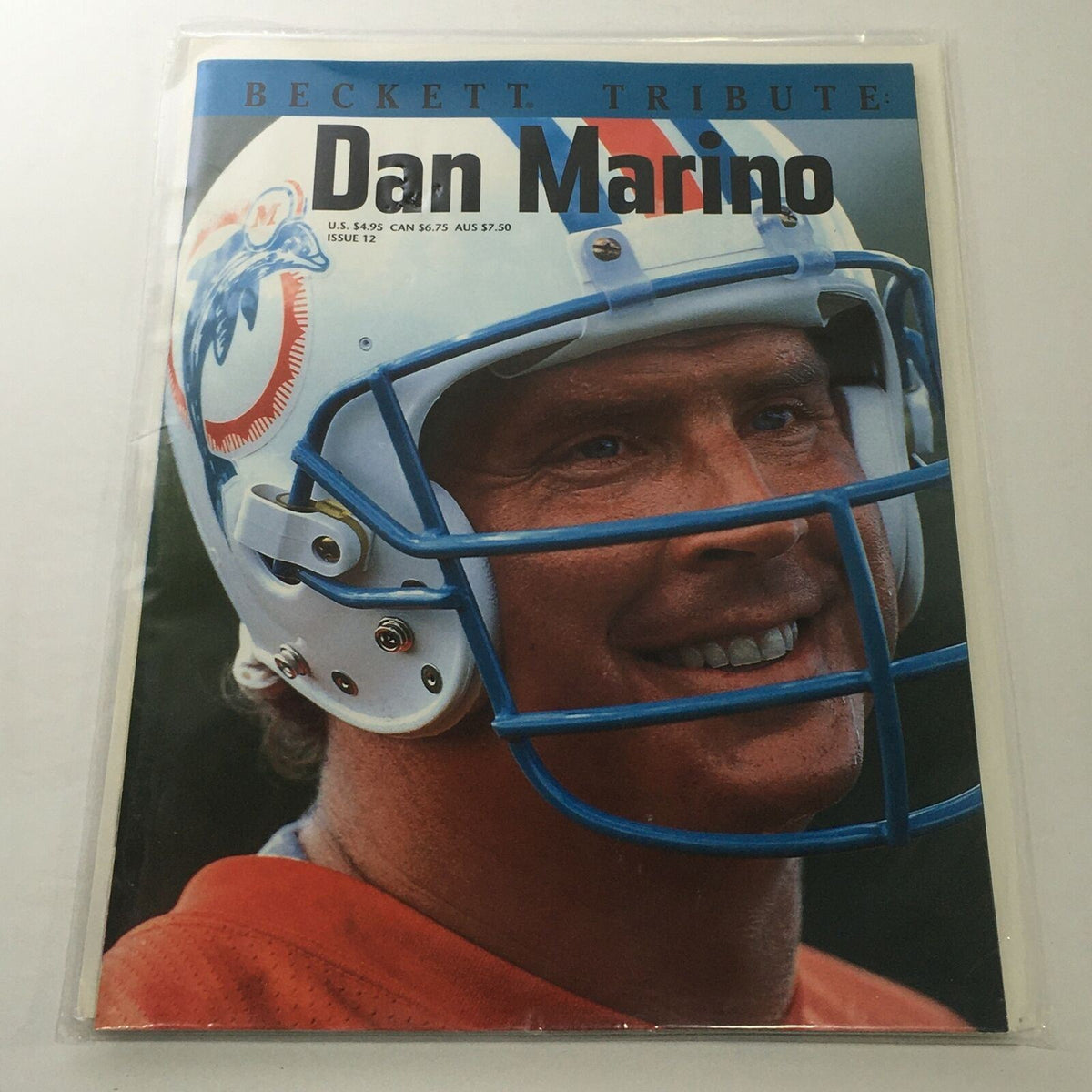 Beckett Tribute: 1995 Issue #12 featuring NFL star Dan Marino smiling while wearing a helmet, representing football memorabilia.