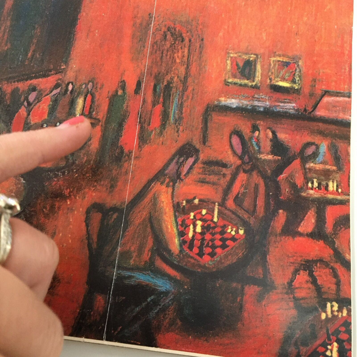 Interior view of The New Yorker Full Magazine January 21 1961, highlighting the chess game illustration by Robert Kraus with a hand pointing at the artwork.