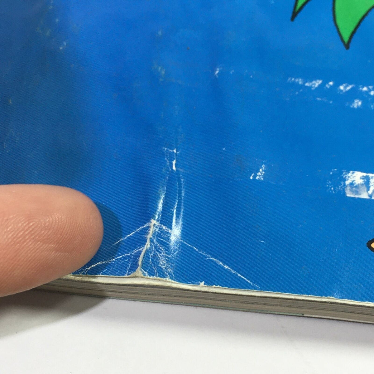 Detail of damage on the cover of The New Yorker Magazine December 7 & 14 1998, highlighting a crease and wear.