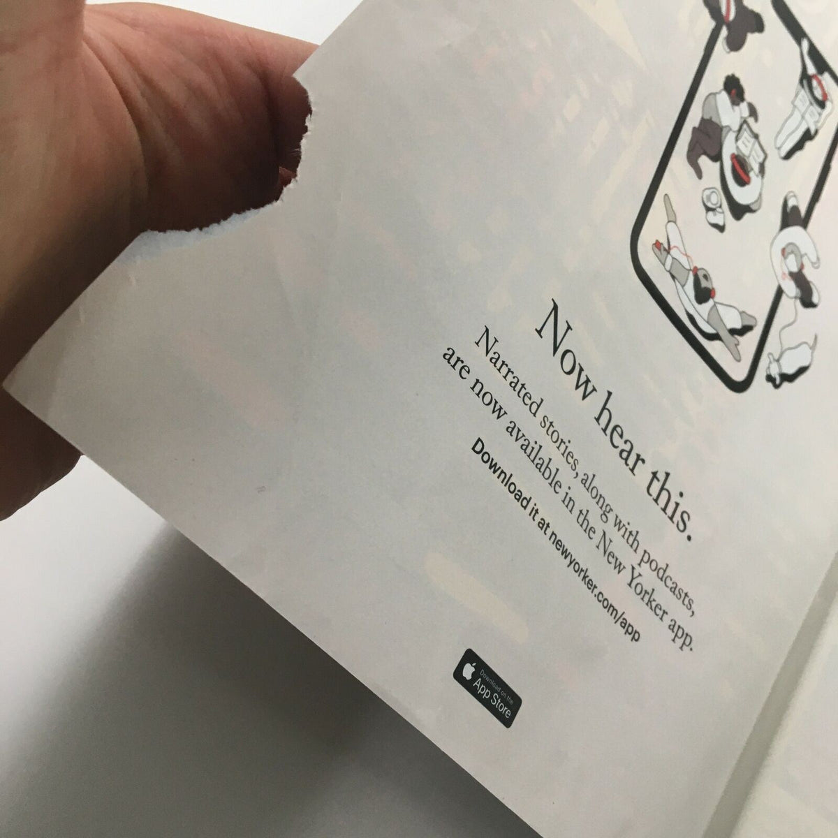 Back inside cover of The New Yorker magazine February 8, 2021, displaying an advertisement for the New Yorker app with a torn corner, reflecting the magazine's digital offerings.