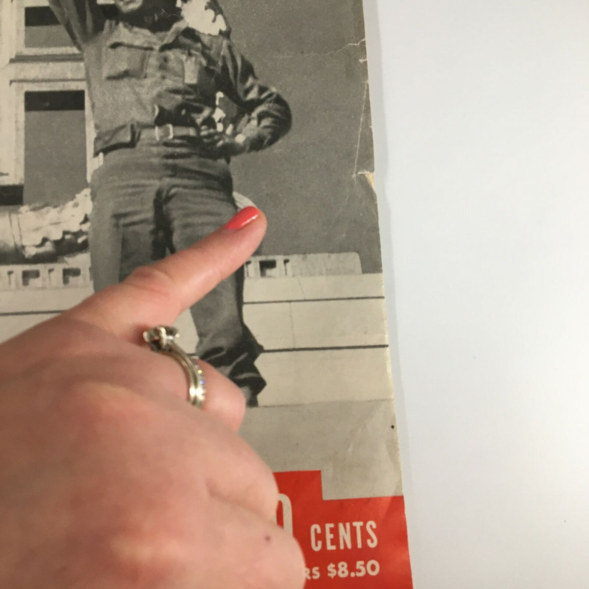 Close-up view of the cover of VTG Life Magazine from May 14, 1945, showcasing a soldier's hand gesturing while standing under a prominent World War II icon.