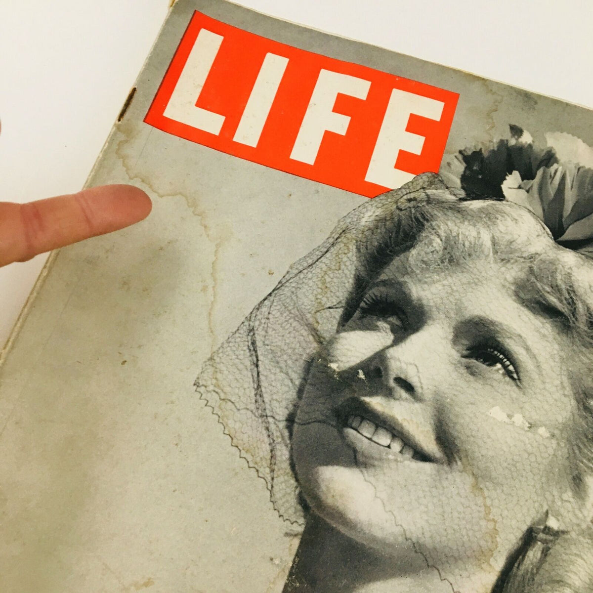 Close-up of the cover of VTG Life Magazine April 28 1941 showing a smiling woman and the title 'LIFE' with minor wear visible.
