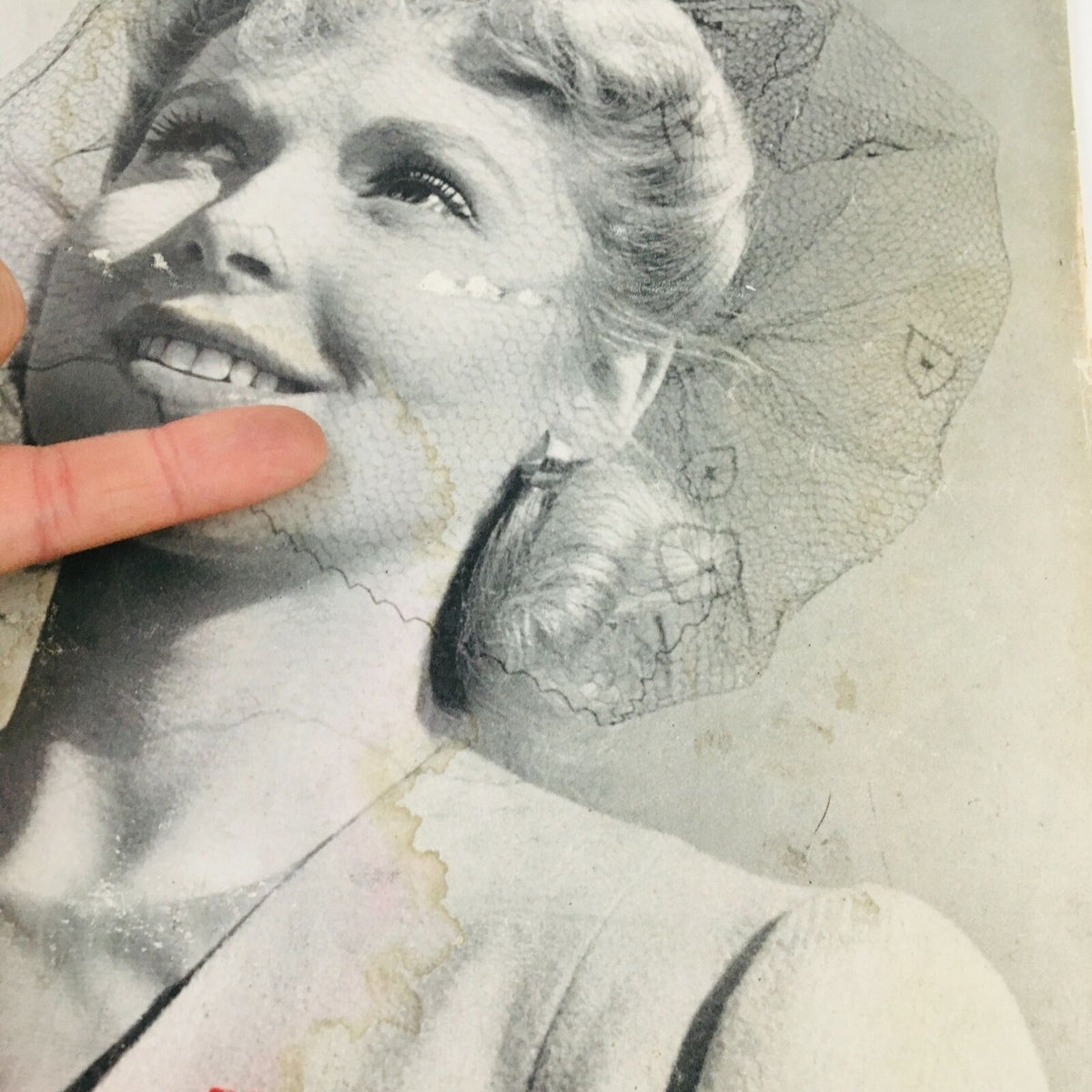 Detail shot of VTG Life Magazine April 28 1941 cover, focusing on the smiling woman and indications of wear on the magazine.
