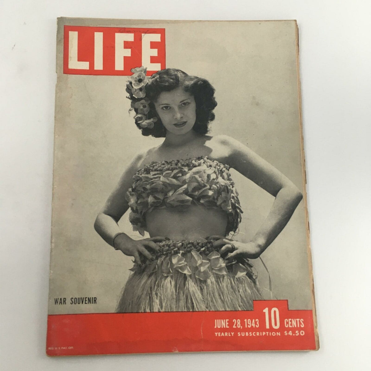 Vintage Life Magazine cover dated June 28, 1943, featuring a woman in traditional attire with floral accents. This War Souvenir edition showcases significant cultural events from World War II.