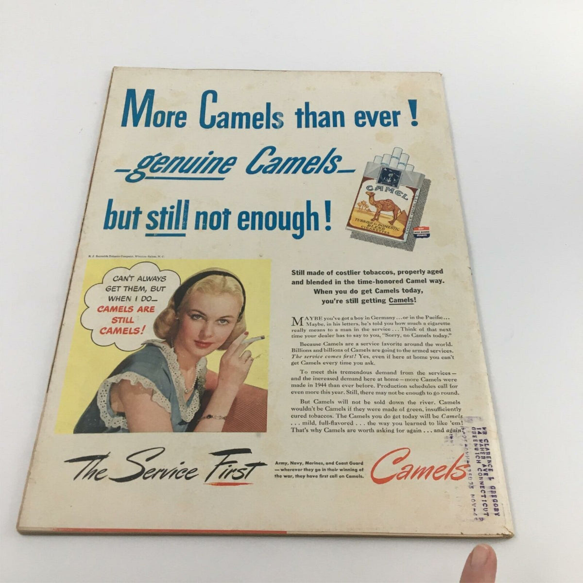 Back cover of the vintage magazine 'VTG Life Magazine July 9 1945 USS Bunker Hill and History of Bathing Suits', featuring an advertisement for Camel cigarettes with a blonde woman and text about the supply of cigarettes during World War II.