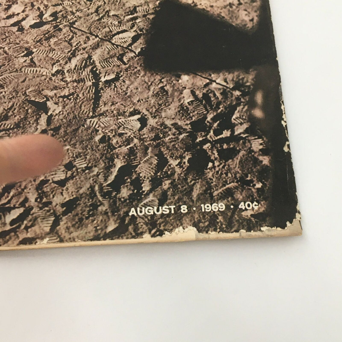 Close-up view of the cover of VTG Life Magazine from August 8, 1969, highlighting the date and details of the moon landing, featuring Apollo 11 footprints.