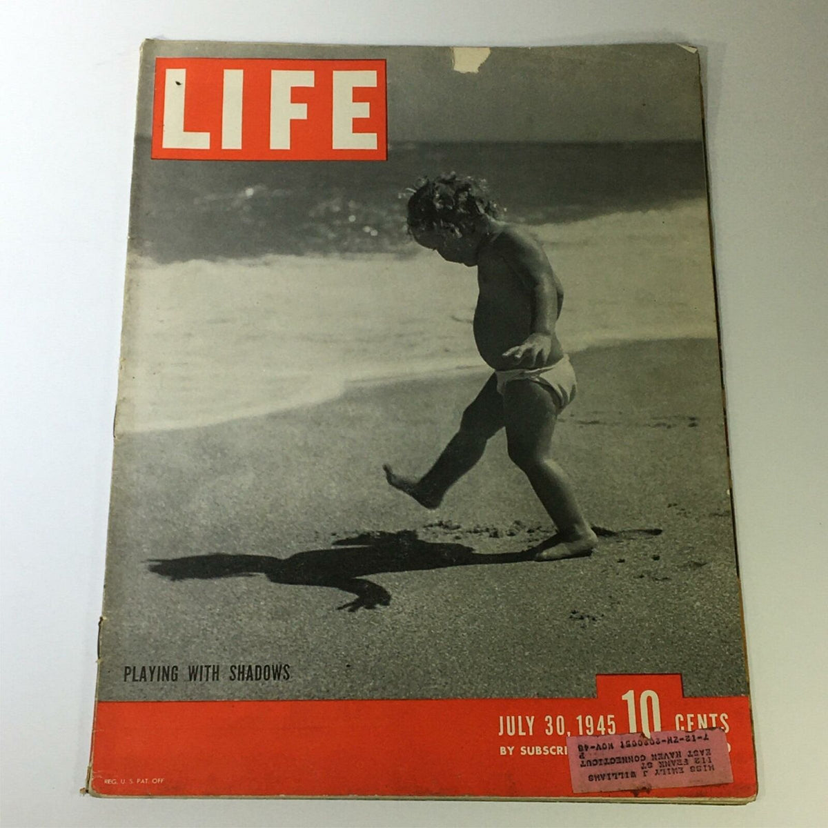 VTG Life Magazine July 30 1945 Playing with Shadows Cover showcasing a child playing at the beach with shadows, highlighting the magazine's vintage appeal and historical significance.