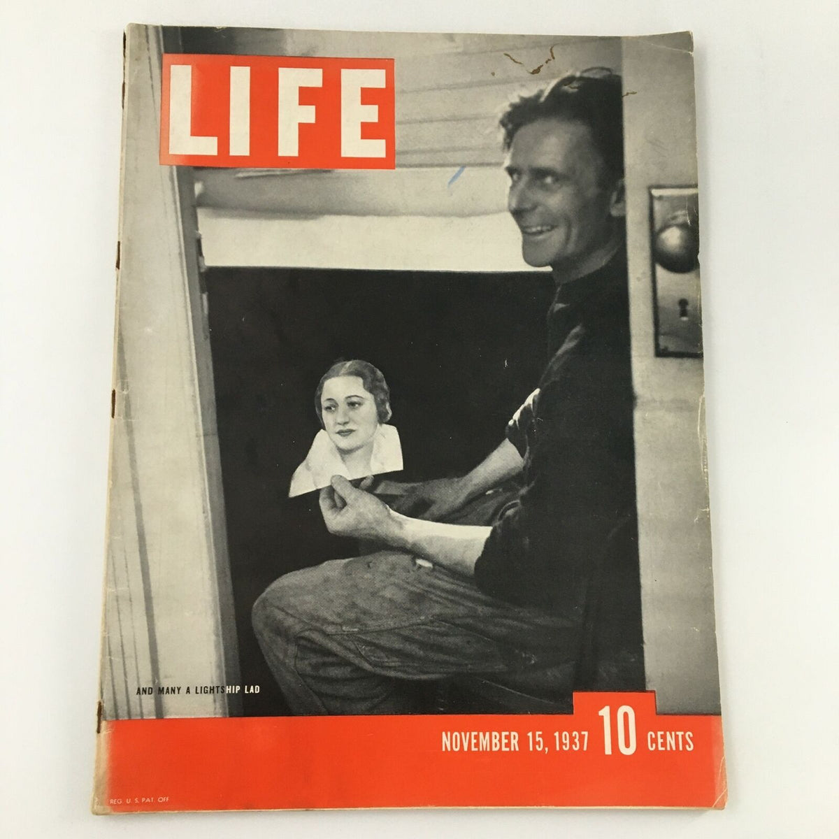 Cover of VTG Life Magazine from November 15, 1937, featuring the article 'And Many A Lights Hip Lad,' showcasing a man seated with a smile, holding a woman's portrait.