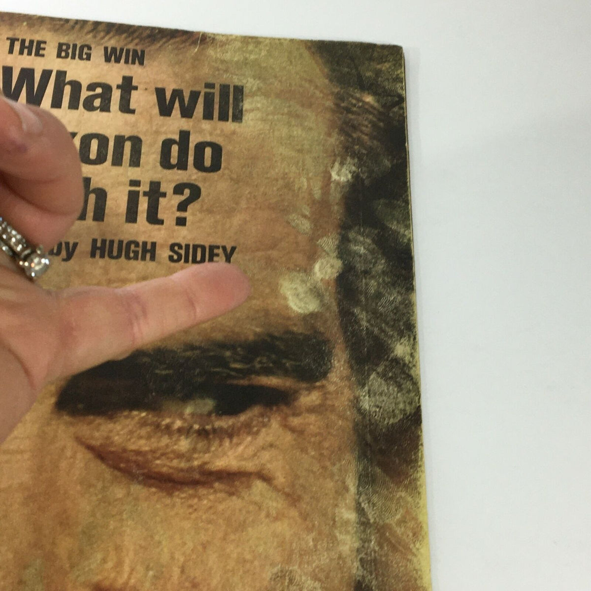 Detailed view of the cover of the November 1972 Life Magazine featuring Richard Nixon, highlighting the title 'The Big Win' and the article by Hugh Sidey, with a finger pointing at Nixon's eye.