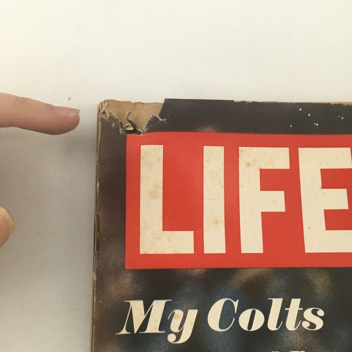 Close-up of the top edge of the VTG Life Magazine December 13, 1968, showing some wear and tear, including a torn corner and markings.