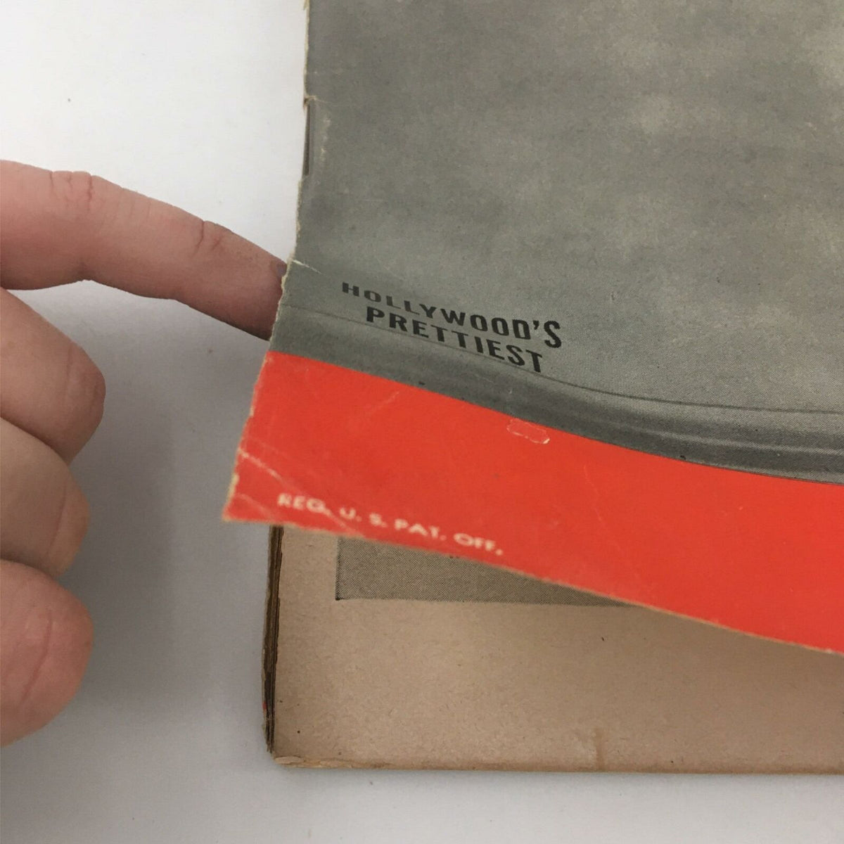 Close-up of the corner of VTG Life Magazine April 17, 1944, displaying the text 'HOLLYWOOD'S PRETTIEST' and showing signs of wear on the magazine cover.