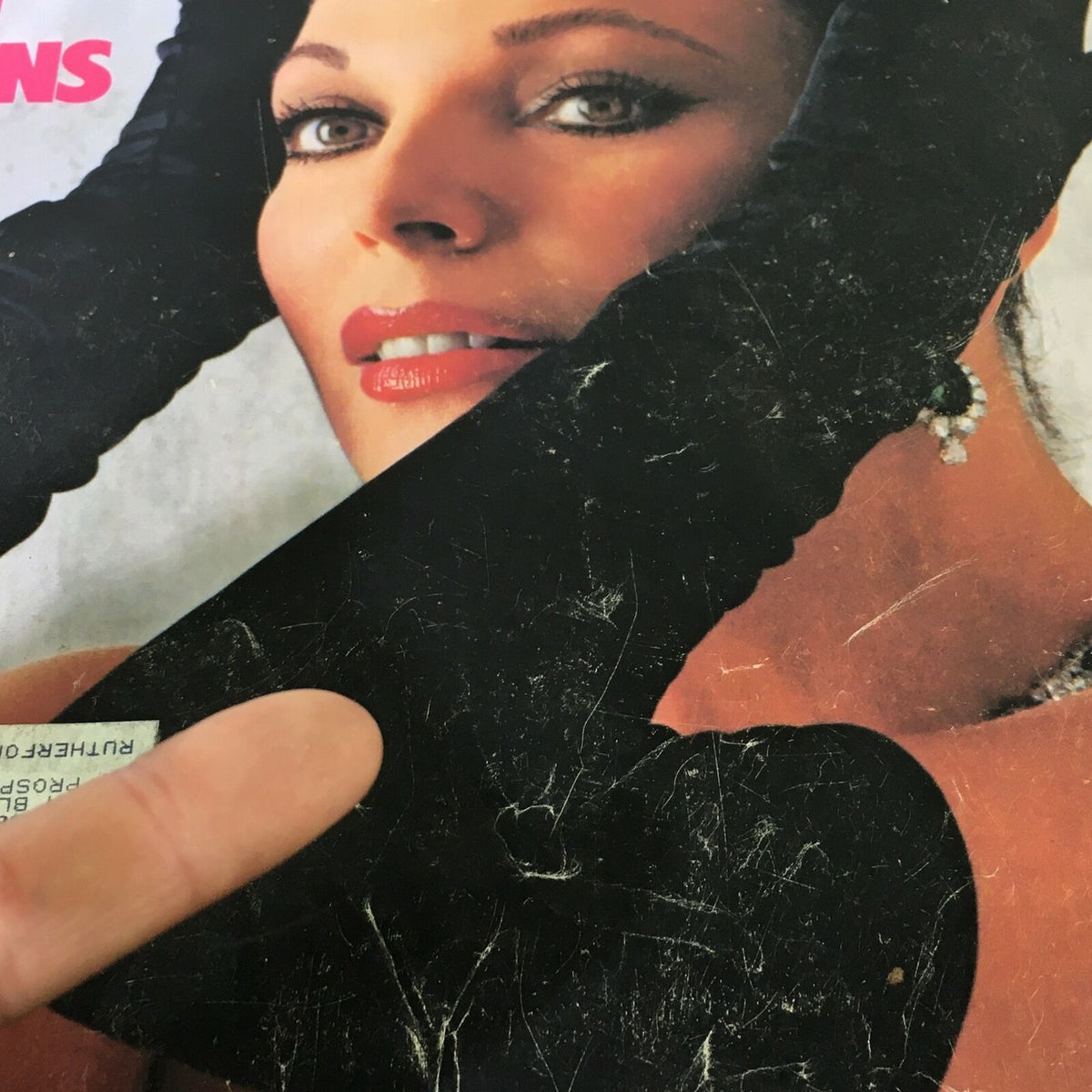 Detailed view of the glam cover of VTG Life Magazine October 1985 with Joan Collins, showcasing her makeup and jewelry.