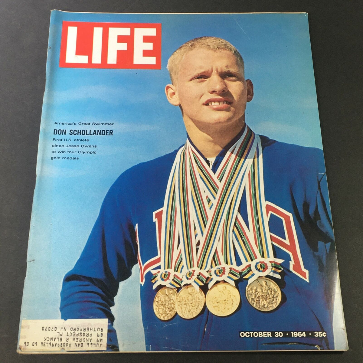 Cover of VTG Life Magazine from October 30, 1964, featuring America's great swimmer Don Schollander, showcasing him wearing multiple Olympic gold medals.
