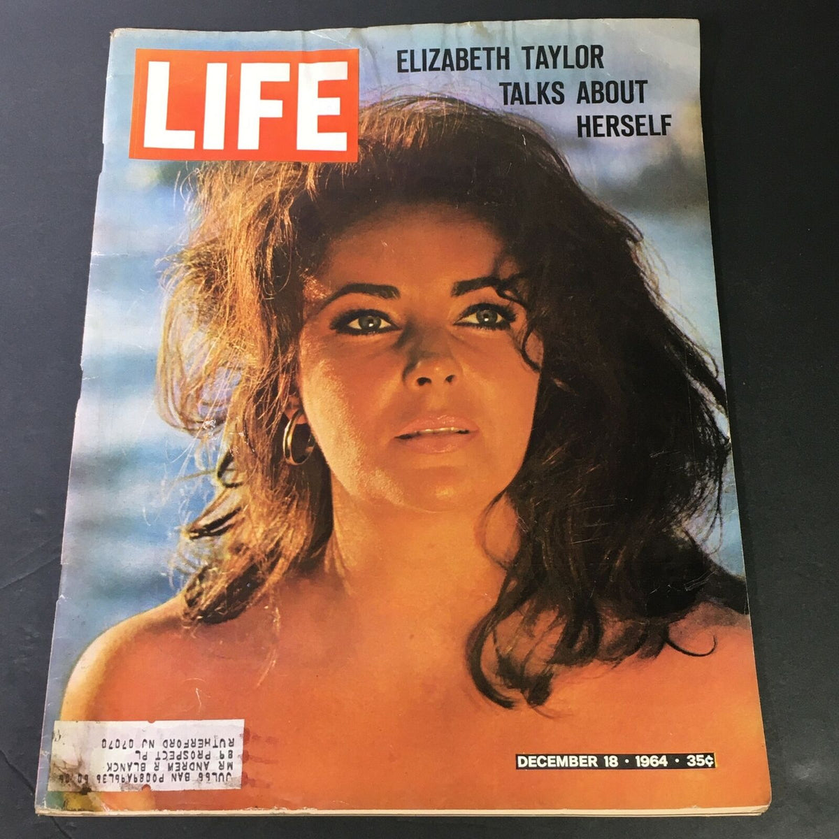 Vintage Life Magazine December 18 1964 featuring Elizabeth Taylor, who discusses her life and experiences. The magazine cover showcases Taylor's iconic beauty with her expressive gaze against a blurred beach background.