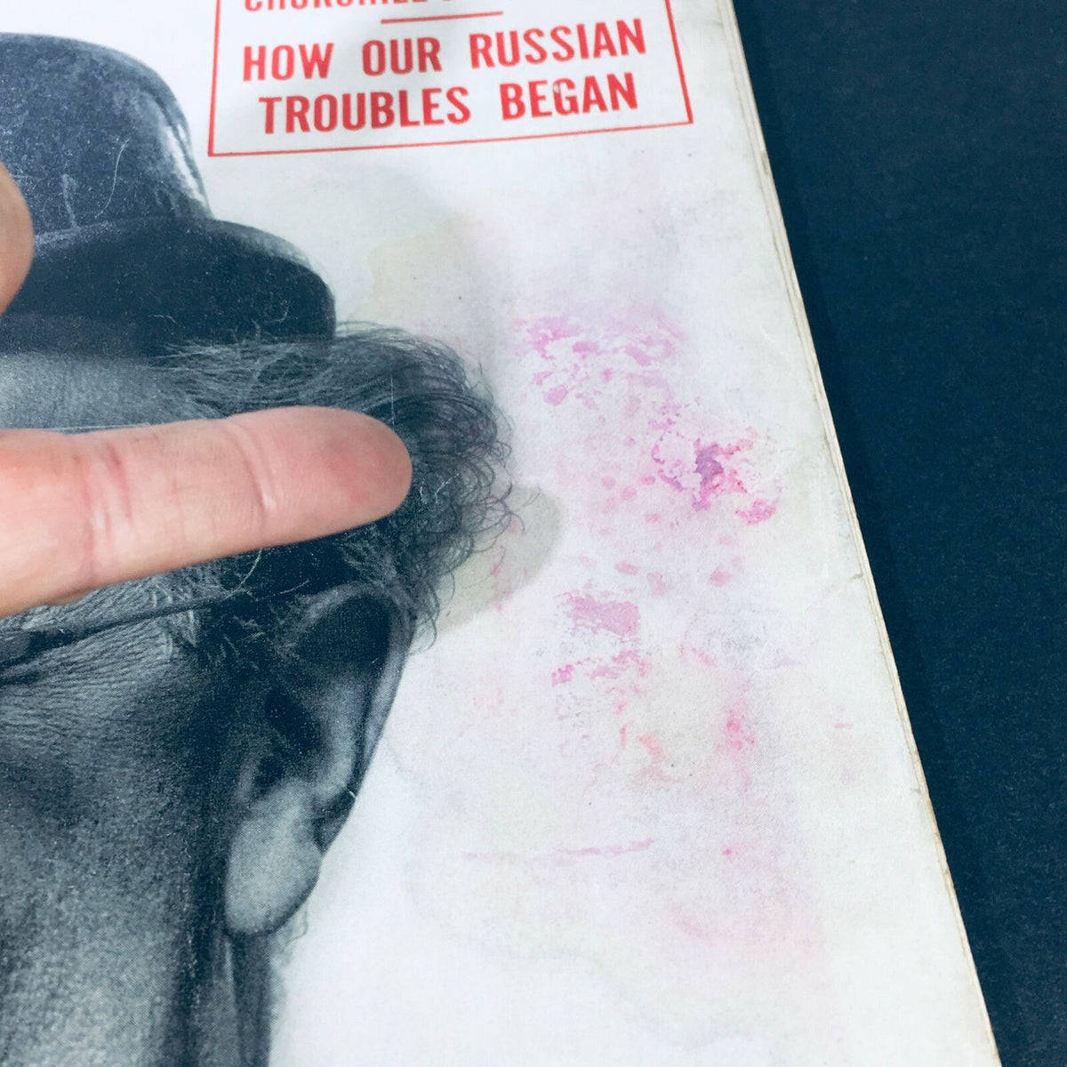 Close-up view of the cover of 'VTG Life Magazine October 23 1950 - Ed Wynn TV Gets Top Comics / Russian Trouble.' The image shows a hand pointing at a faded section with discoloration and marks, highlighting the magazine's vintage condition.