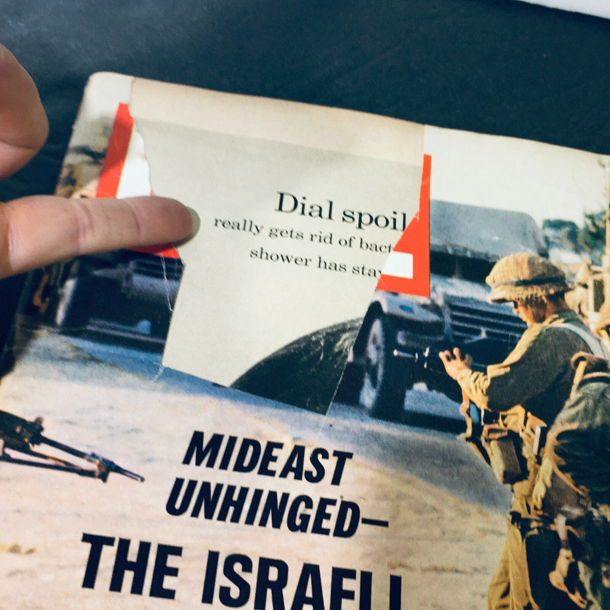 Detail view of the cover of VTG Life Magazine June 16 1967 - Mideast Unhinged: The Israeli Onslaught, highlighting a torn corner with a label and soldiers in action.