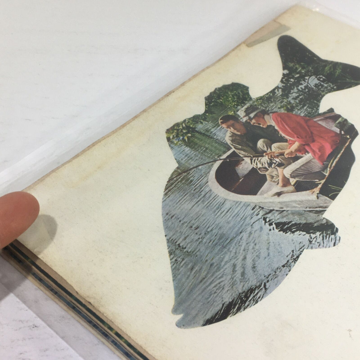 Interior detail from Life Magazine dated April 14, 1967, showcasing a cutout of a fishing scene, providing a glimpse into the vintage advertisements featured.