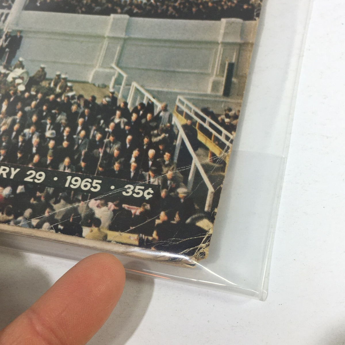 Another close-up of the corner of VTG Life Magazine - January 29 1965, highlighting wear along the edge and a glimpse of the iconic inaugural event crowd.