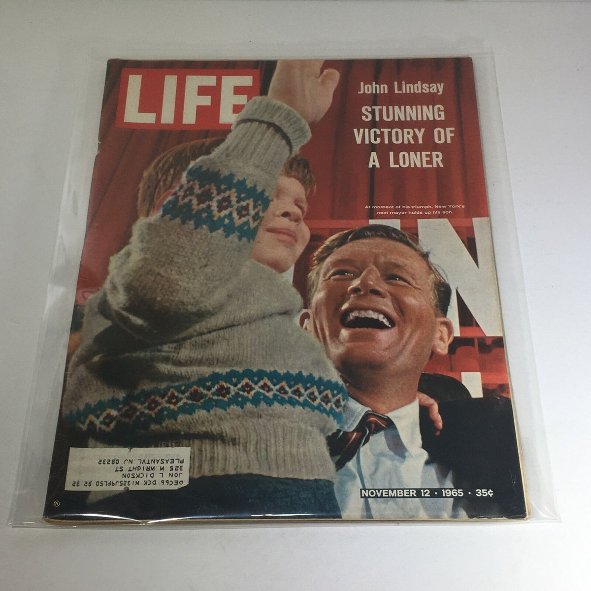 Cover of VTG Life Magazine from November 12, 1965 featuring John Lindsay and the headline 'Stunning Victory of A Loner'. The image displays Lindsay celebrating with a child, highlighting a significant political moment.