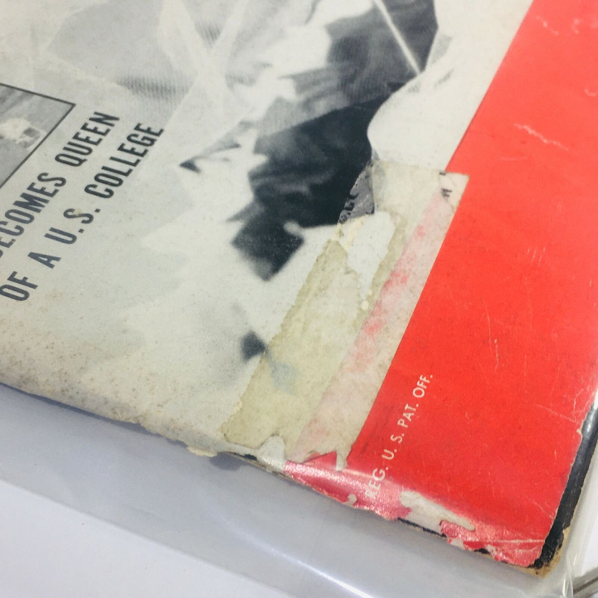 Detail of the back cover of VTG Life Magazine from December 15, 1952, showcasing the worn edges and headlines related to the College Queen feature, preserved in a plastic cover.