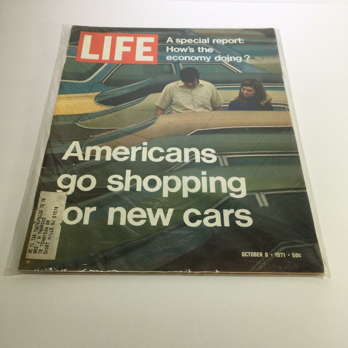 Life Magazine October 8, 1971 cover featuring the headline 'Americans Go Shopping for New Cars' and a depiction of a couple examining vehicles, reflecting the economic climate of the time.