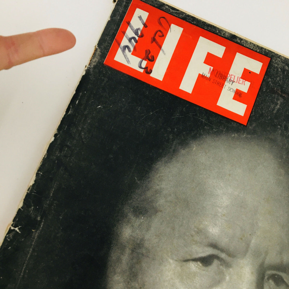 Close-up of the cover of VTG Life Magazine October 23 1944, highlighting the title and an inscription 'Life' with a fingerprint pointing at it, showcasing its vintage character.