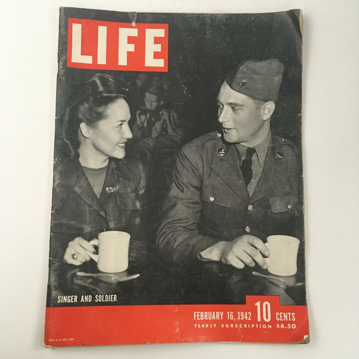 Life Magazine February 16, 1942 cover featuring a photograph of a singer and a soldier sharing a moment over coffee, capturing the essence of World War II camaraderie and cultural expression.
