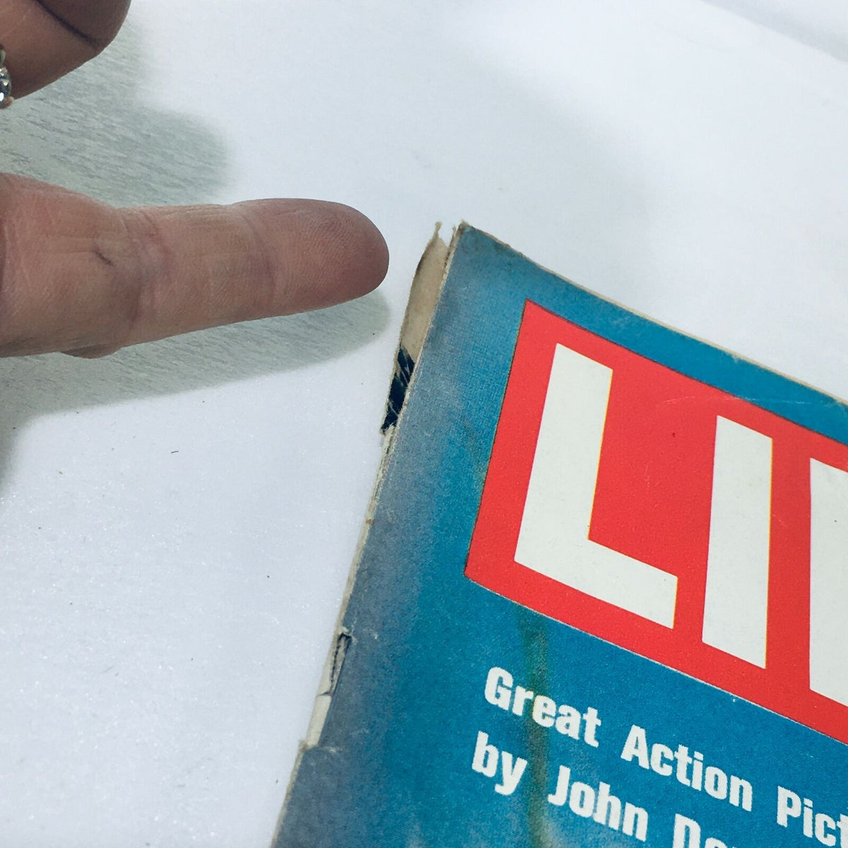 Close-up of the edge of the VTG Life Magazine from December 5, 1969, highlighting minor wear and a small rip, indicating its vintage condition.