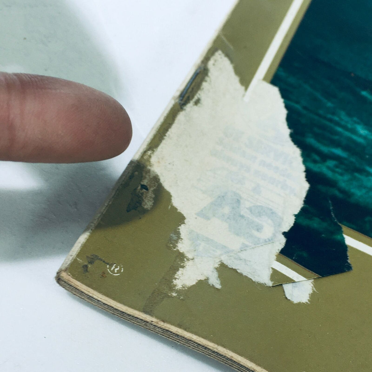 Close-up of the edge of the July 9, 1971, Vintage Life Magazine cover showing wear and a torn area, highlighting its authentic vintage condition, with address label remnants.