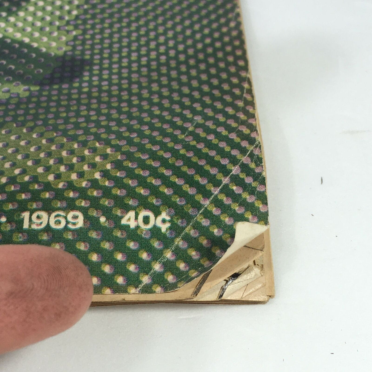 Close-up view of the corner of a vintage Life Magazine from April 4, 1969, showcasing the date '1969' and the price '40¢', connected to the issue titled 'Sex In The Lively Arts, How Far Is Far Enough?'. Highlighting its collectible nature and vintage condition.