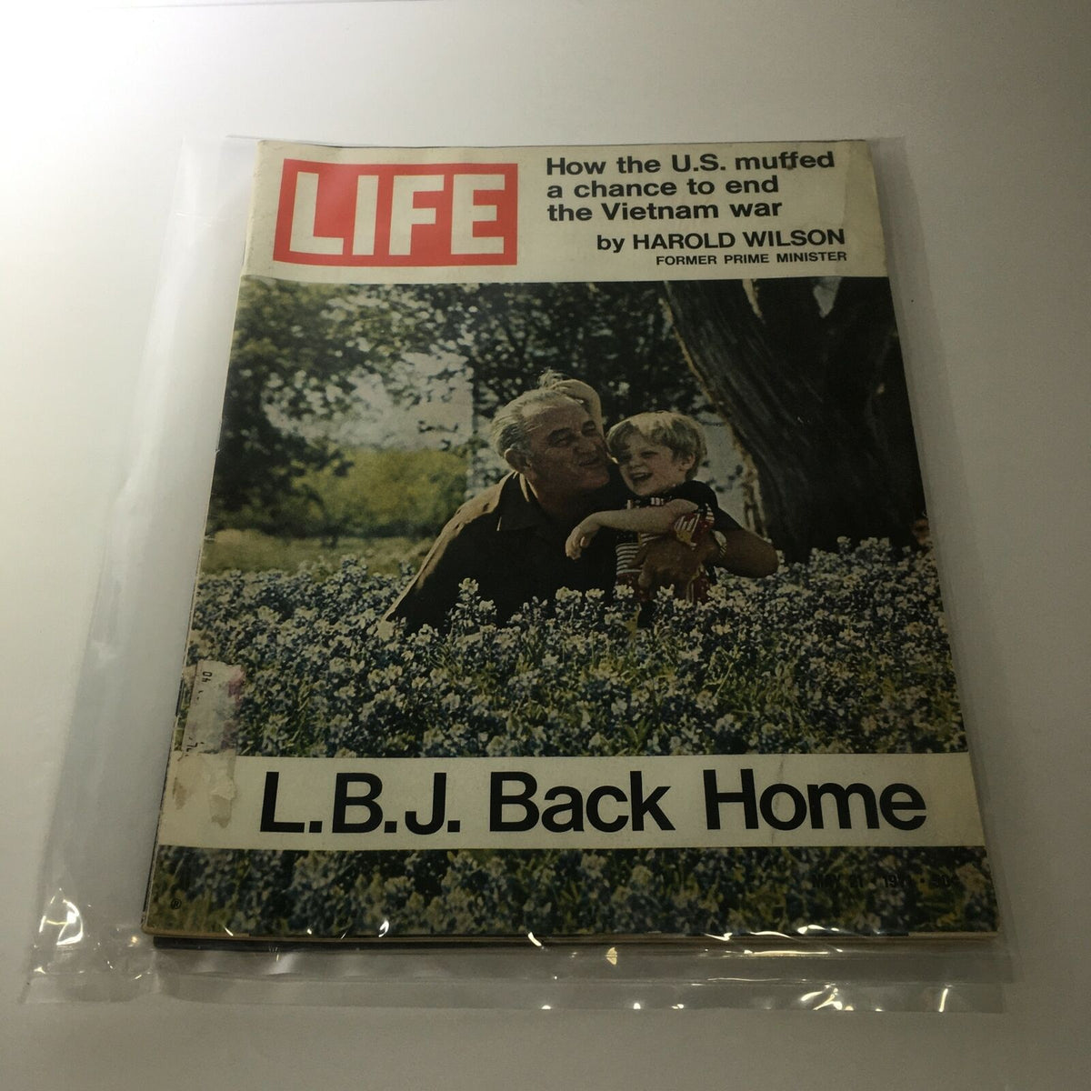 Cover of Life Magazine dated May 21, 1971, featuring the title 'L.B.J. Back Home' with a photograph of a smiling Lyndon B. Johnson with a child in a field of blue flowers, emphasizing the Vietnam War context.