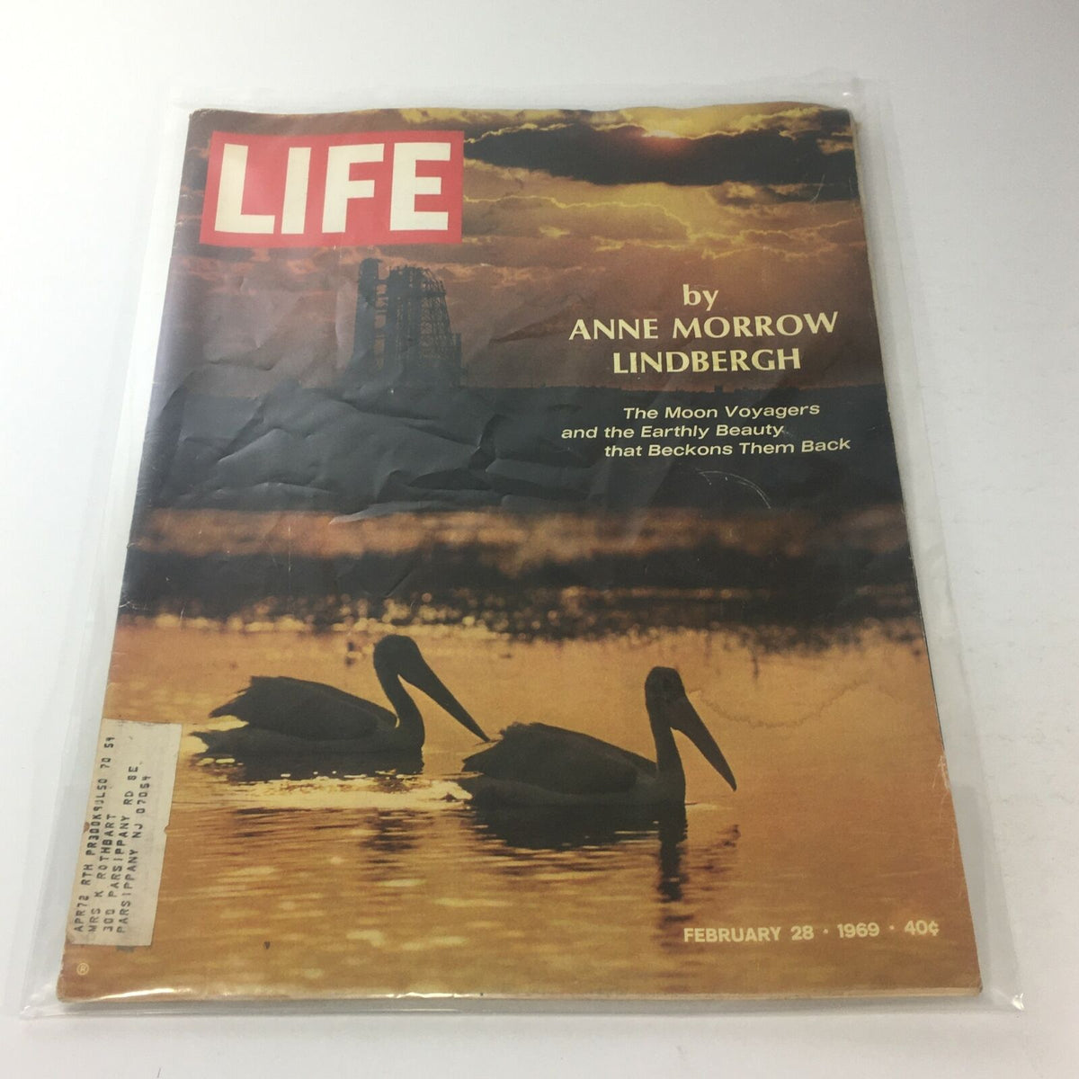 Cover of VTG Life Magazine dated February 28, 1969, featuring the title 'The Moon Voyagers' by Anne Morrow Lindbergh, showcasing a serene sunset with two pelicans on water, capturing the essence of space exploration and earthly beauty.